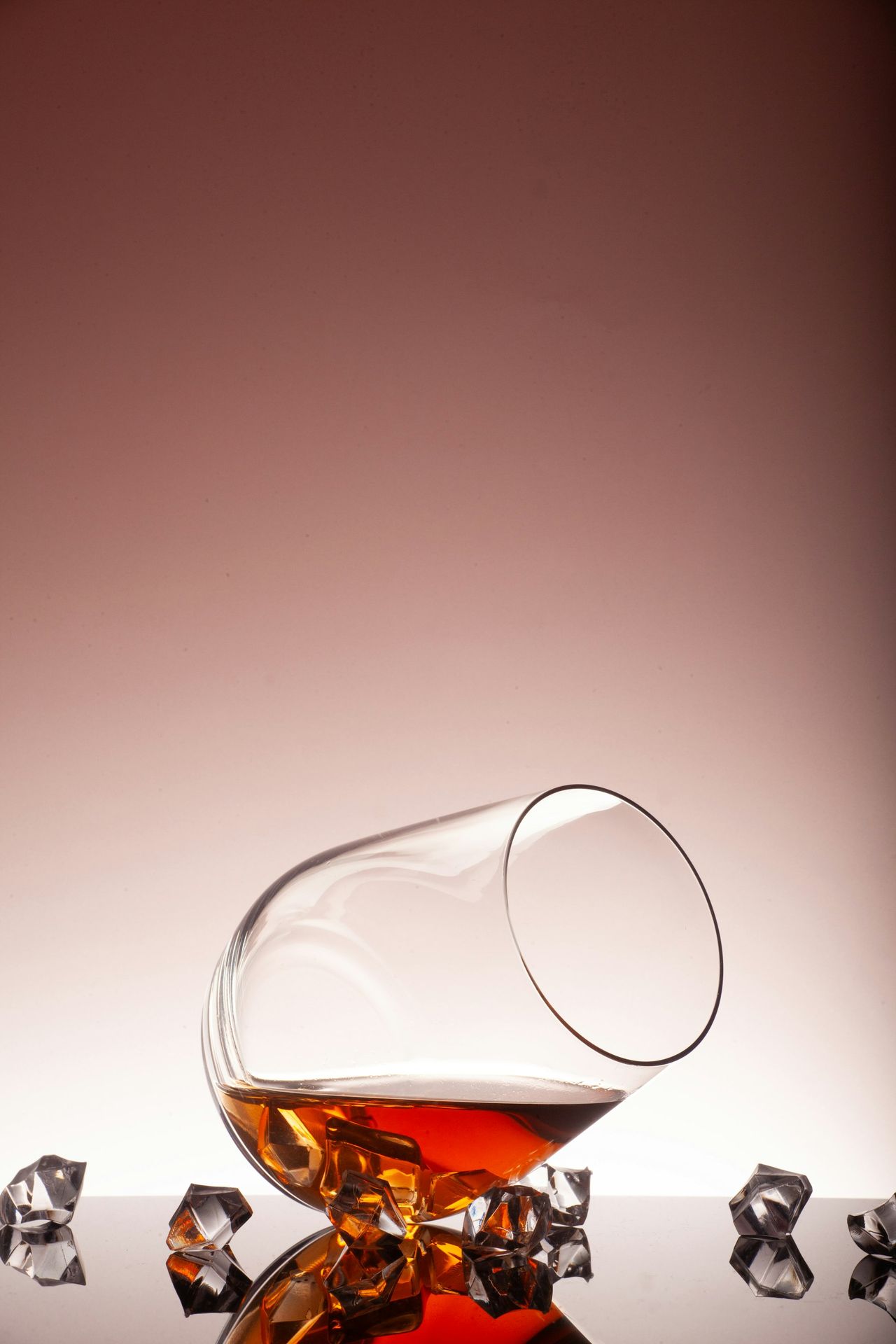 A glass filled with liquid sitting on top of ice cubes