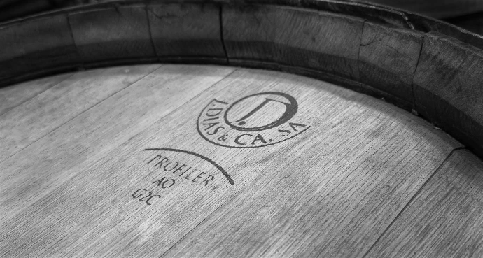 Wooden barrel with logo visible.